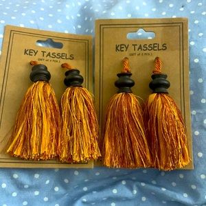 4 Burnt orange tassels.